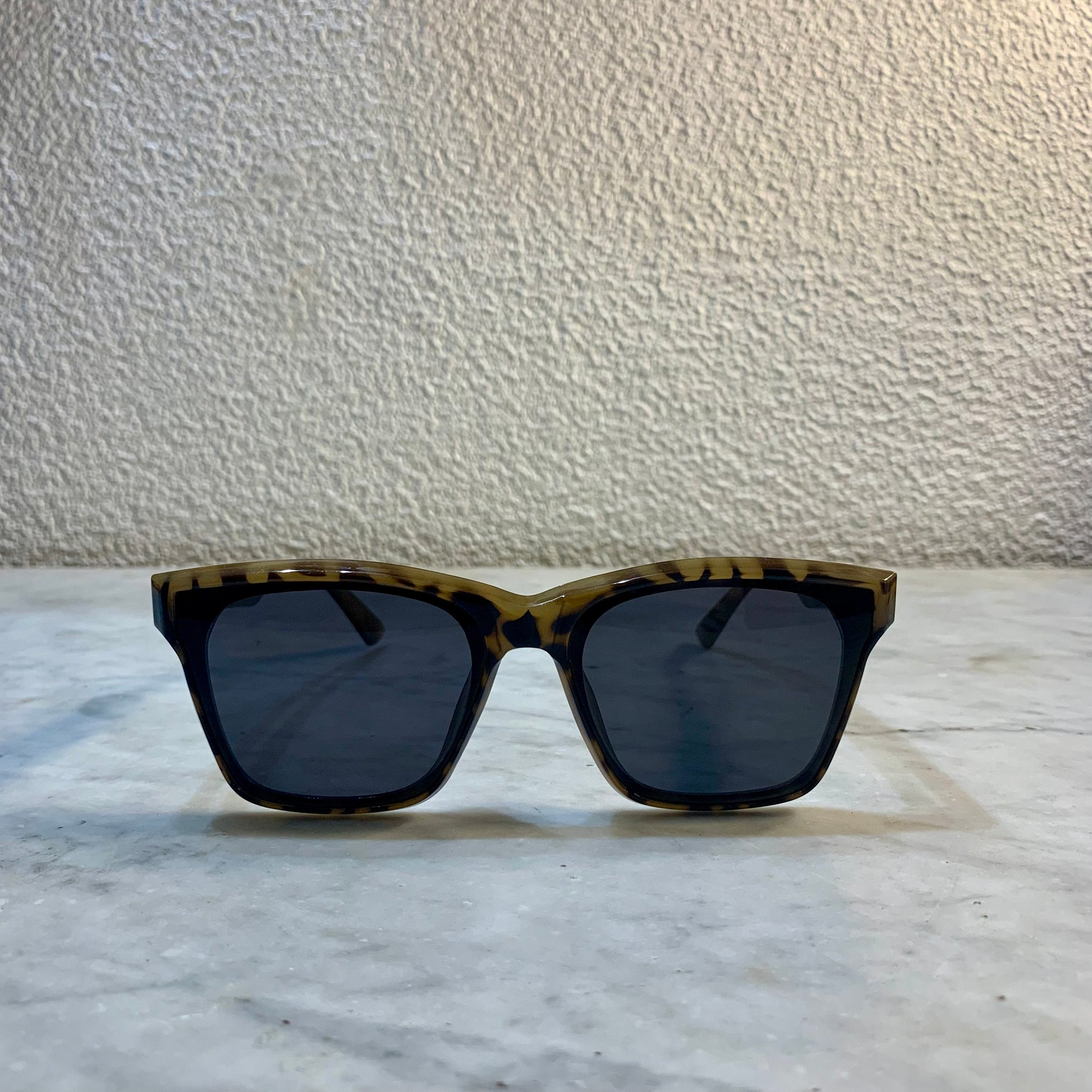 lunettes de soleil Pinigoon ecaille la numero 13 oeil de chat sur buffet marbre